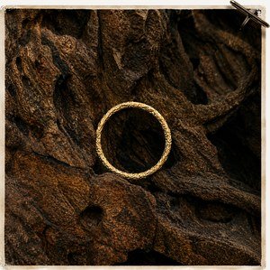 Gold band resting on bark