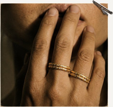 Hand wearing stacked gold bands