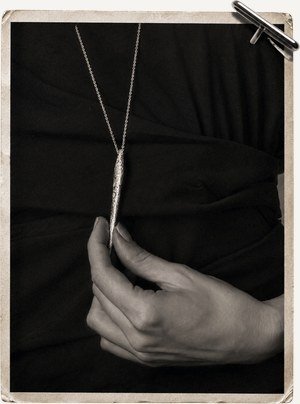 Long pendant necklace on black
