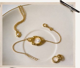 Gold chain bracelets on linen