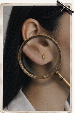 Hoop earring worn with stacked rings