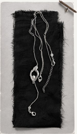 Chain study laid on dark cloth