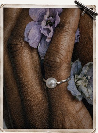 Hand with rings and pressed flowers